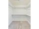 Spacious walk-in closet featuring carpeted floors and plenty of shelving at 430 N Keystone Ave, Indianapolis, IN 46201