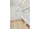 Bright entryway featuring a white door and built-in bench seating with shelving and hooks for organization at 430 N Keystone Ave, Indianapolis, IN 46201