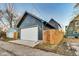 Garage with a white door and gray siding, complemented by wooden fences, located in a neighborhood setting at 430 N Keystone Ave, Indianapolis, IN 46201