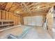 Spacious unfinished garage featuring exposed framing, shelving, and ample storage space at 430 N Keystone Ave, Indianapolis, IN 46201