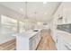 Bright kitchen featuring a center island, modern pendant lighting, and plenty of cabinet space at 430 N Keystone Ave, Indianapolis, IN 46201