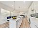Bright kitchen featuring a center island, modern pendant lighting, and stools for seating at 430 N Keystone Ave, Indianapolis, IN 46201