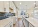 Modern kitchen features stainless steel appliances, white cabinets, and a spacious island with a sink at 430 N Keystone Ave, Indianapolis, IN 46201
