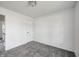 Bright bedroom featuring neutral walls, gray carpet, and a door, offering a cozy and minimalist space at 431 Alton Dr, Greenwood, IN 46143