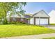 Charming one-story home with manicured lawn and two-car garage on a sunny day at 431 Alton Dr, Greenwood, IN 46143