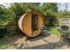 Private backyard featuring a unique sauna, stone patio, greenery, and a small sitting area at 4901 N Kenwood Ave, Indianapolis, IN 46208
