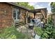 Brick home featuring a backyard patio with dining area, string lights, and outdoor seating at 4901 N Kenwood Ave, Indianapolis, IN 46208