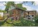Charming brick home featuring a cozy backyard with a dining area, patio, and lush green landscaping at 4901 N Kenwood Ave, Indianapolis, IN 46208