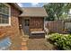 Brick home featuring a backyard with a door to a small storage building at 4901 N Kenwood Ave, Indianapolis, IN 46208