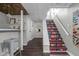 Finished basement stairs featuring floral patterned risers, and dark wood flooring at 4901 N Kenwood Ave, Indianapolis, IN 46208