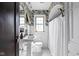 Charming bathroom with patterned wallpaper, white wainscoting, and mosaic tile flooring at 4901 N Kenwood Ave, Indianapolis, IN 46208