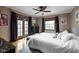 Relaxing bedroom featuring hardwood floors, neutral decor, dark accents, and a ceiling fan at 4901 N Kenwood Ave, Indianapolis, IN 46208