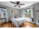 Bright and cozy bedroom features hardwood floors, sun-filled windows, and minimalist decor at 4901 N Kenwood Ave, Indianapolis, IN 46208