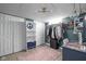 Basement closet with open shelving, hanging racks, and neutral tiled flooring at 4901 N Kenwood Ave, Indianapolis, IN 46208