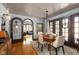 Charming dining room with hardwood floors, arched doorways, and vintage-inspired chandelier at 4901 N Kenwood Ave, Indianapolis, IN 46208