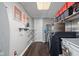 Laundry room with modern washer and dryer, shelving, and folding area at 4901 N Kenwood Ave, Indianapolis, IN 46208