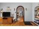 Arched doorway view into the dining room, with hardwood floors and traditional decor at 4901 N Kenwood Ave, Indianapolis, IN 46208
