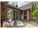 Cozy covered patio with seating area, brick accents, and charming decor at 4901 N Kenwood Ave, Indianapolis, IN 46208