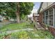 Side yard showing nice lawn and landscaping details, and a partial view of the home's brick exterior at 4901 N Kenwood Ave, Indianapolis, IN 46208