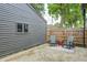 Cozy backyard patio space with two chairs and a small table at 5144 N College Ave, Indianapolis, IN 46205