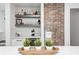 Close-up of the bar with exposed brick and display shelves at 5144 N College Ave, Indianapolis, IN 46205