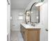 Bathroom with double sink vanity, mirrors and white subway tile at 5144 N College Ave, Indianapolis, IN 46205