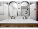 Bathroom featuring double vanity with mirrors and modern lighting at 5144 N College Ave, Indianapolis, IN 46205