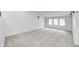 Bright, spacious bedroom with a window seat, carpeted floors, and modern lighting at 5144 N College Ave, Indianapolis, IN 46205