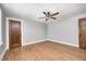 Empty bedroom featuring hardwood floors, ceiling fan and two doors at 5144 N College Ave, Indianapolis, IN 46205