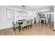 Elegant dining room with modern lighting, hardwood floors, and ample natural light at 5144 N College Ave, Indianapolis, IN 46205