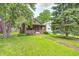 Charming brick home with a well-manicured lawn and mature trees, offering a welcoming curb appeal at 5144 N College Ave, Indianapolis, IN 46205