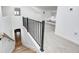 Bright hallway with white walls, with a view to a bedroom with a bay window, and wooden stairs at 5144 N College Ave, Indianapolis, IN 46205