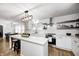 Bright kitchen featuring white cabinets, stainless appliances, and a view to the dining area at 5144 N College Ave, Indianapolis, IN 46205
