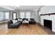 Bright living room featuring hardwood floors, a cozy fireplace, and ample seating at 5144 N College Ave, Indianapolis, IN 46205