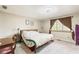 Comfortable bedroom features soft carpet, a bed with patterned linens, and a window with brown curtains at 5530 Pilgrim Dr, Indianapolis, IN 46254
