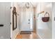 Inviting entryway with hardwood floors, a front door with decorative glass, a coat rack and decorative mirror at 5530 Pilgrim Dr, Indianapolis, IN 46254