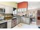 Bright eat-in kitchen features gray cabinets, tiled backsplash, stainless appliances and an adjacent dining area at 5530 Pilgrim Dr, Indianapolis, IN 46254