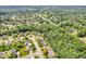 Aerial view of a neighborhood with tree-lined streets and cul-de-sacs surrounded by green spaces at 5865 Osage Dr, Carmel, IN 46033