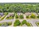 A neighborhood aerial view showcasing homes with manicured lawns and mature trees at 5865 Osage Dr, Carmel, IN 46033