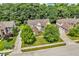 An aerial view of a home situated on a lot with mature trees and professional landscaping at 5865 Osage Dr, Carmel, IN 46033