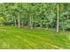 Expansive backyard with lush green lawn and mature trees offering ample privacy at 5865 Osage Dr, Carmel, IN 46033