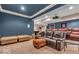 Basement featuring movie projector, leather furniture, ottoman, accent pillows, and workout equipment at 5865 Osage Dr, Carmel, IN 46033