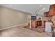 Basement bar area with stone-look floor and updated lighting and bar appliances at 5865 Osage Dr, Carmel, IN 46033
