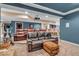 Finished basement with movie projector, plush seating area, exercise equipment and bar area at 5865 Osage Dr, Carmel, IN 46033