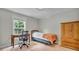 A serene bedroom, featuring abundant natural light, a desk, and closet for storage at 5865 Osage Dr, Carmel, IN 46033