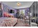 Cozy purple bedroom with TV, decorated with unique wall hangings and ample space for a desk at 5865 Osage Dr, Carmel, IN 46033