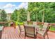 Stained wood deck with dining table, upholstered chairs, market umbrella, and ornamental railings at 5865 Osage Dr, Carmel, IN 46033