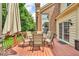 Stained wood deck featuring a dining table with comfortable upholstered chairs and market umbrella at 5865 Osage Dr, Carmel, IN 46033