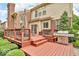 Stained wood deck featuring a stainless steel grill, ornamental metal railings and comfortable outdoor furniture at 5865 Osage Dr, Carmel, IN 46033