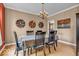 Formal dining room features unique wall decorations, chandelier and access to other rooms at 5865 Osage Dr, Carmel, IN 46033